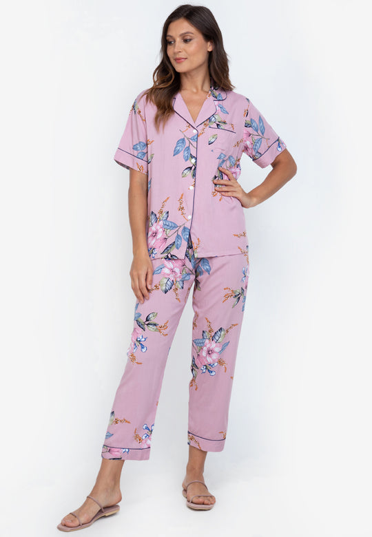 A woman standing and wearing a cotton shortsleeve pajama set