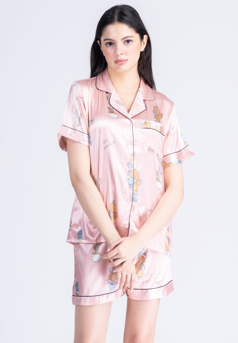 A woman standing and wearing a short sleeve pajama set