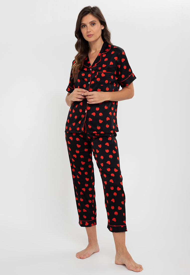 A woman standing and wearing as short sleeve pajama set