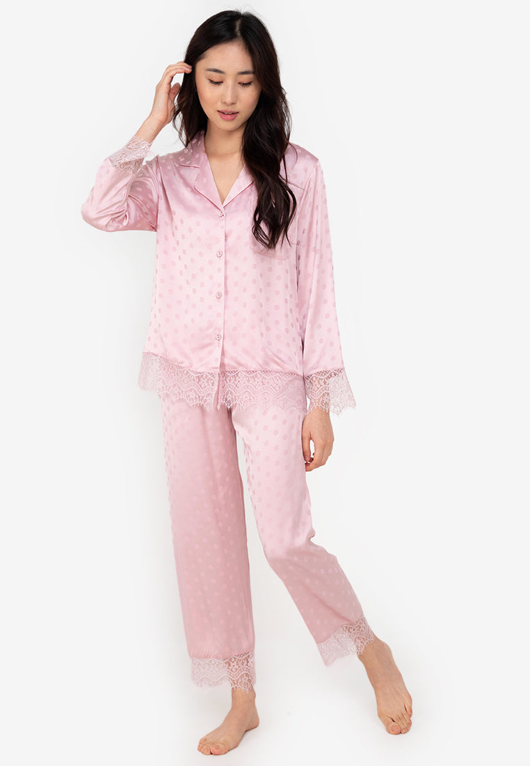 A woman wearing a silk long sleeve pajama set