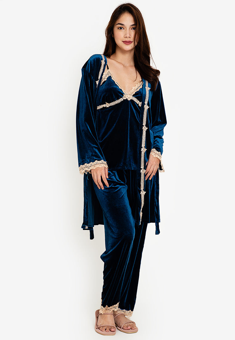 A woman standing and wearing velvet robes