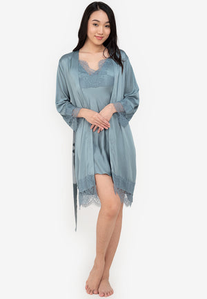 A woman wearing a slip dress in a robe blue