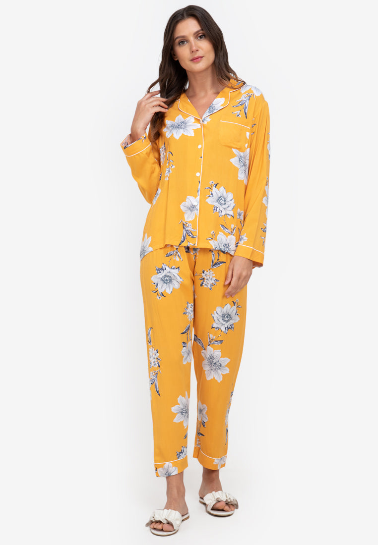 A woman standing and wearing a long sleeve floral cotton pajama set