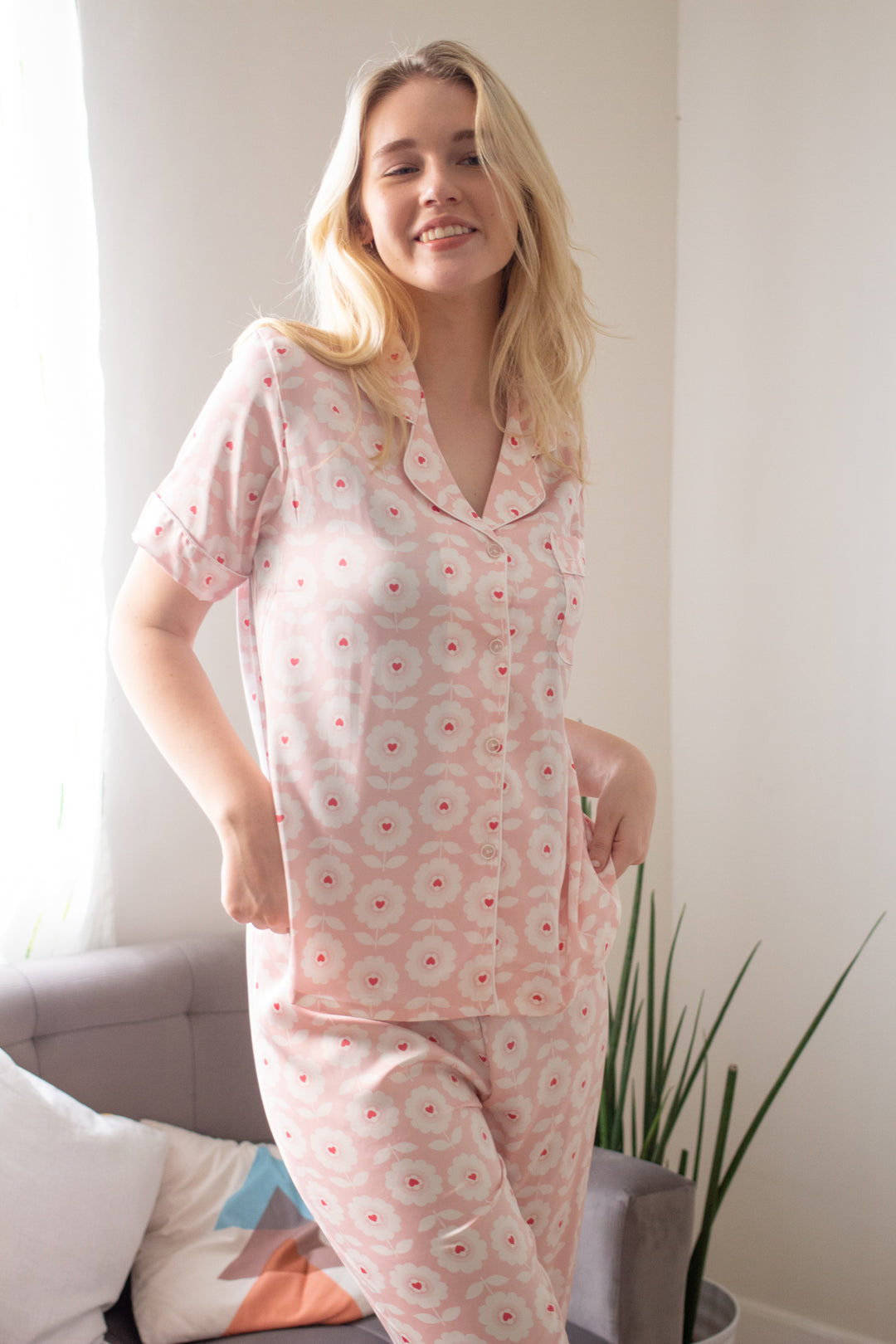 A woman wearing a silk short sleeve pajama set