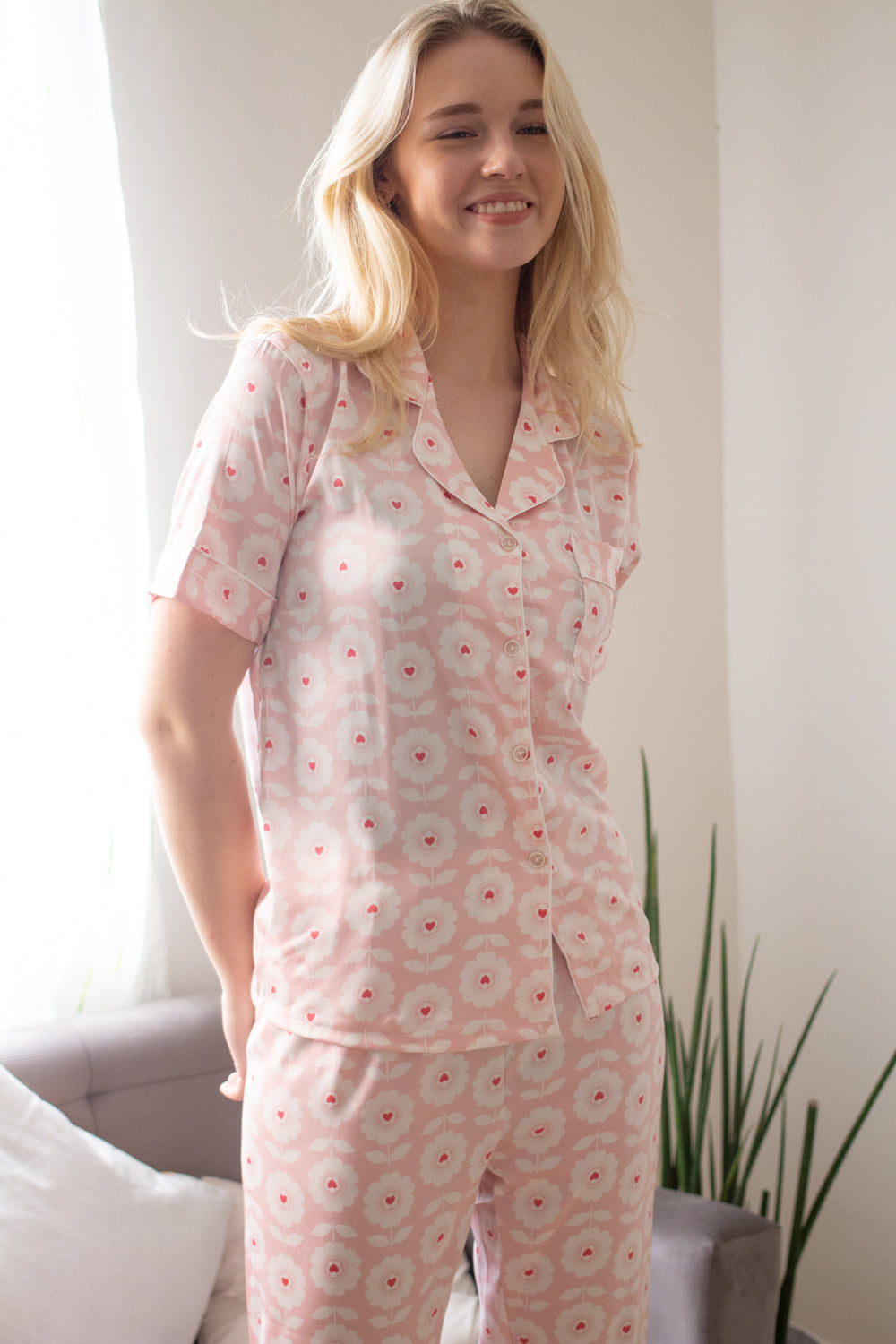 A woman wearing a silk short sleeve pajama set