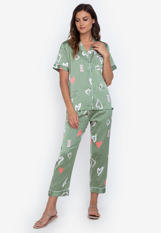 A woman standing and wearing silk short sleeve pajama set