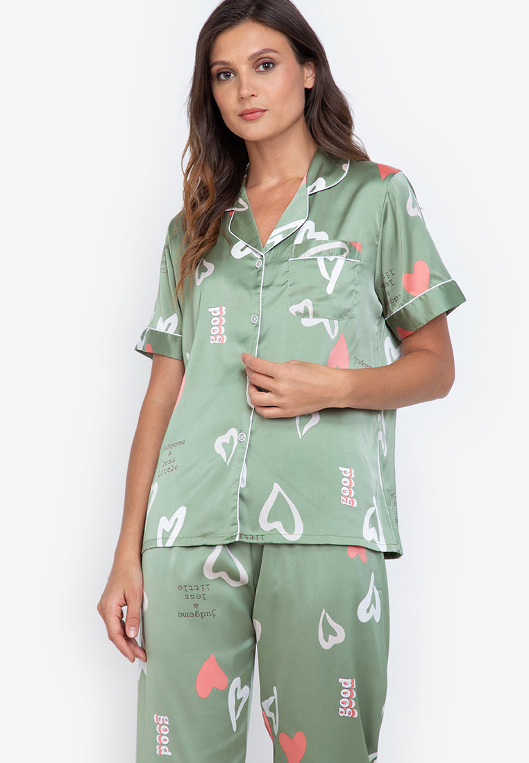 A woman standing and wearing silk short sleeve pajama set