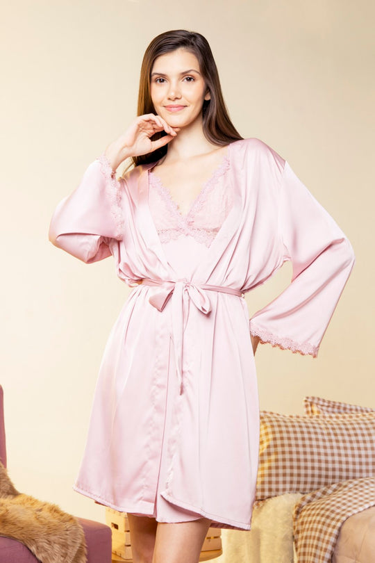 A woman wearing a slip dress top in a robe