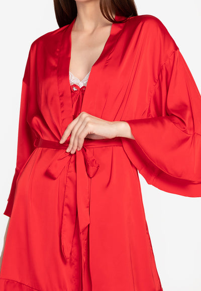 A woman wearing a slip dress in a robe