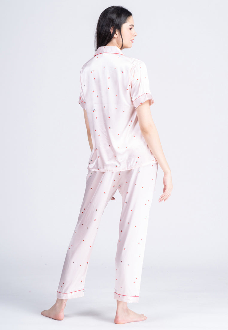 A woman wearing a silk short sleeve pajama set