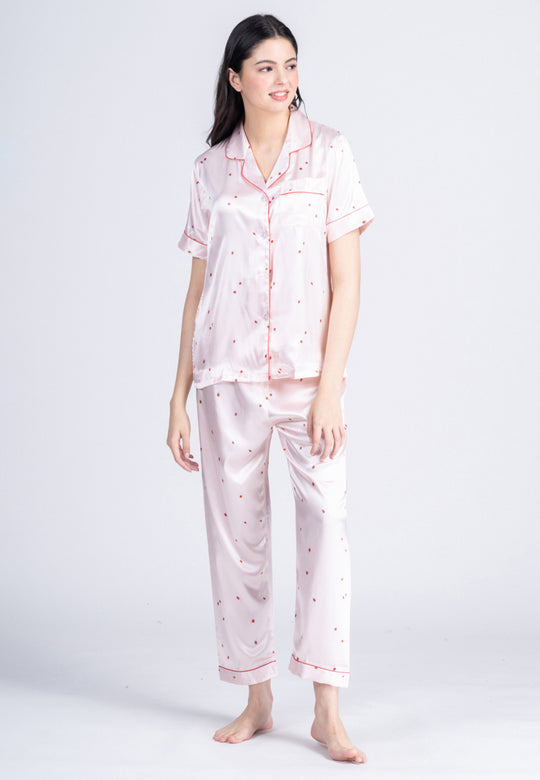 A woman wearing a silk short sleeve pajama set