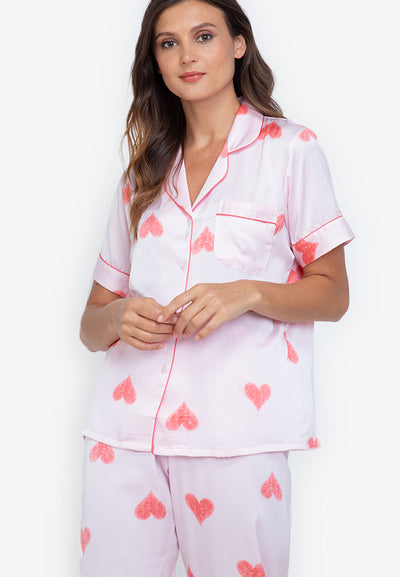 A woman standing and wearing a short sleeve pajama set